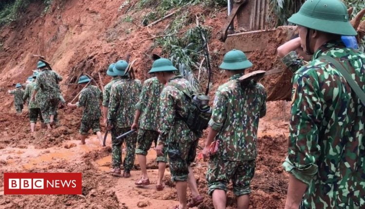 Vietnam landslide: Rescuers search for survivors at barracks