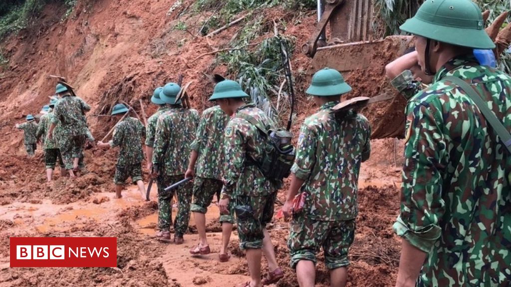 Vietnam landslide: Rescuers search for survivors at barracks
