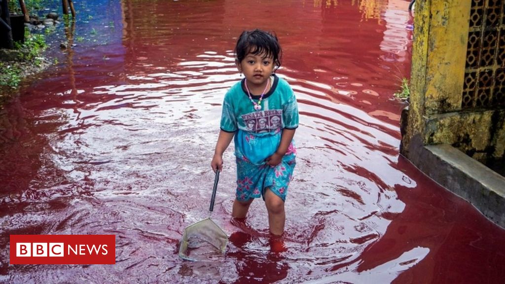 Village submerged by red water after flood hits batik factory